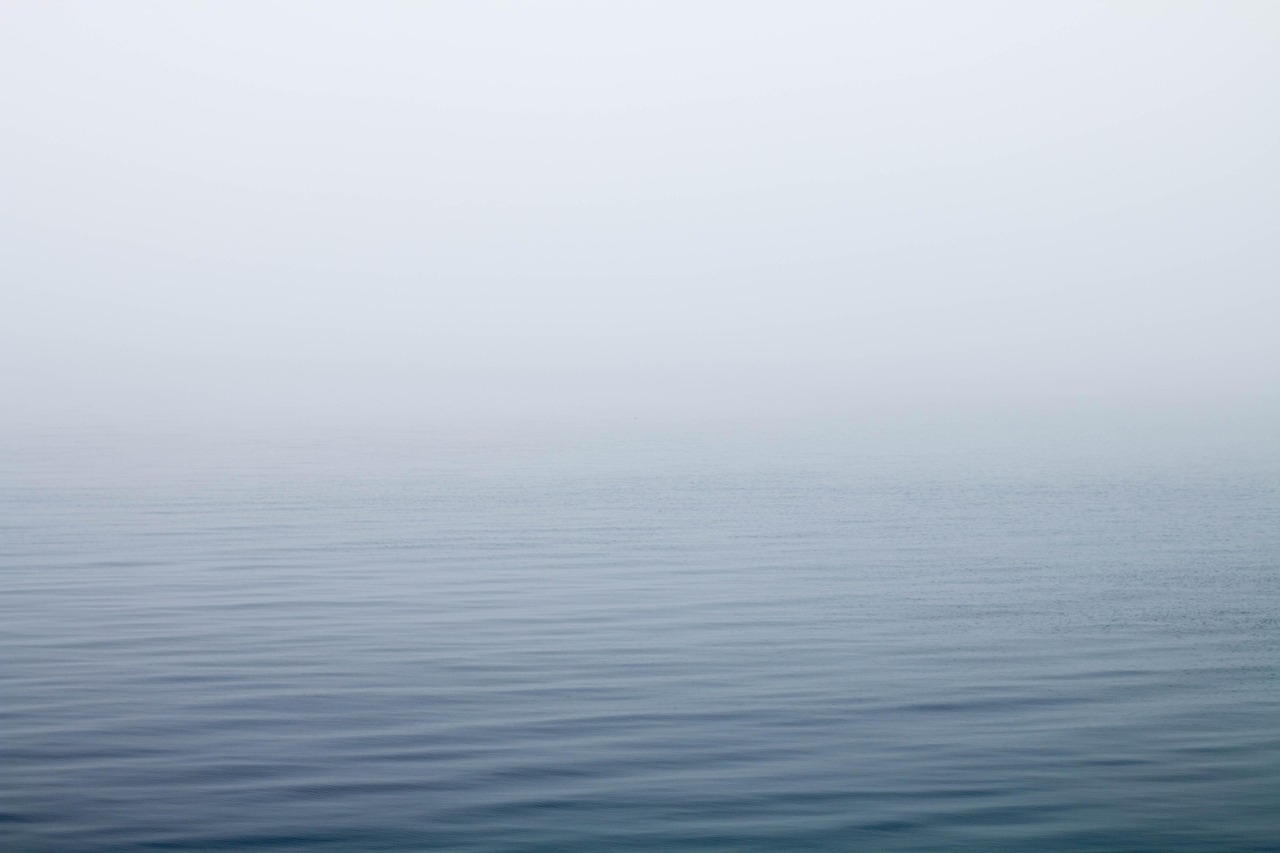 foggy, calm lake water, sets the mysterious tone