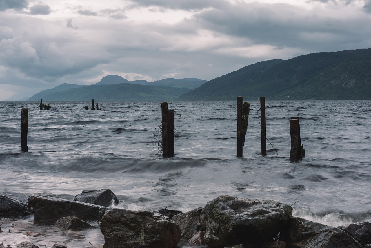 Loch Ness-stranden med gamla stolpar och kullar